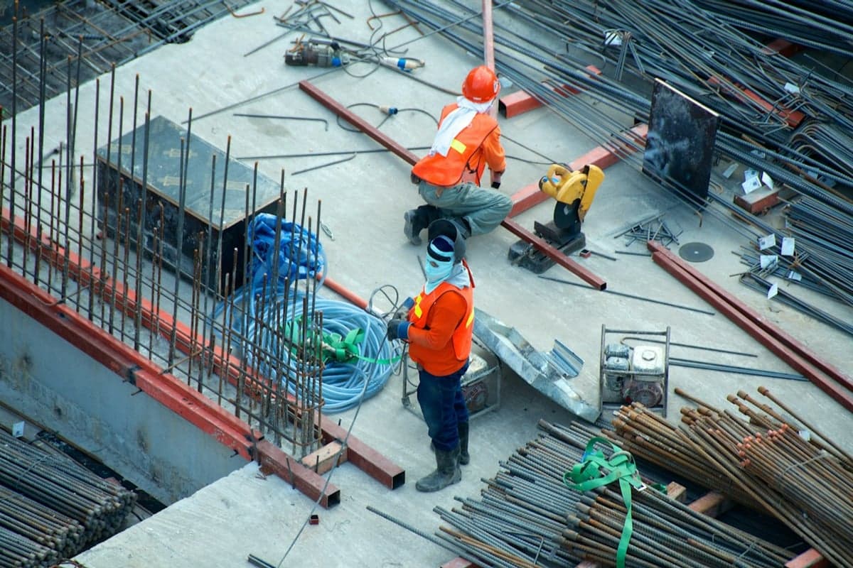 Low-rise building civil construction site with engineers and reinforcement steel in India